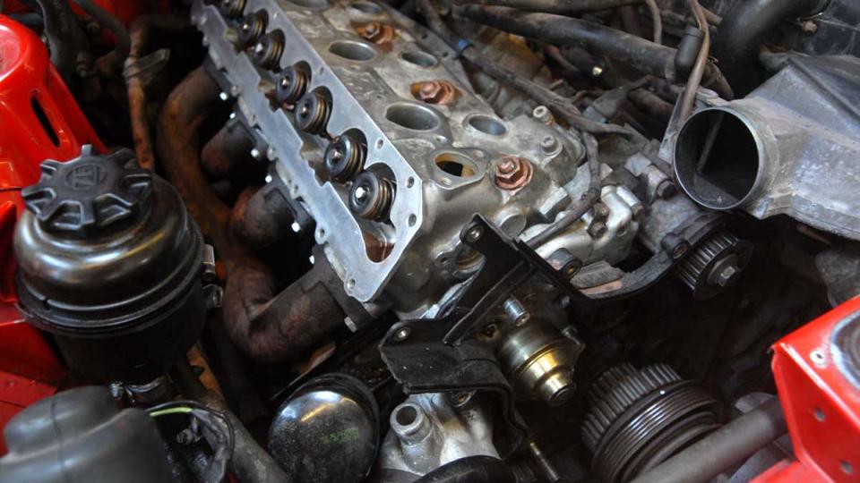 Porsche 944 8 valve head being fitted after head gasket replacement