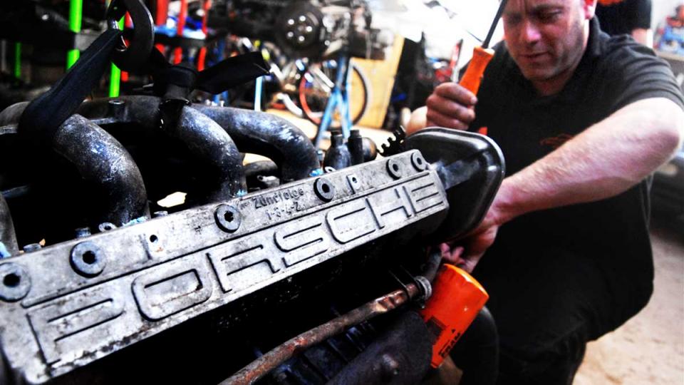 Dave works to refit the Porsche 944 engine after refurbishment