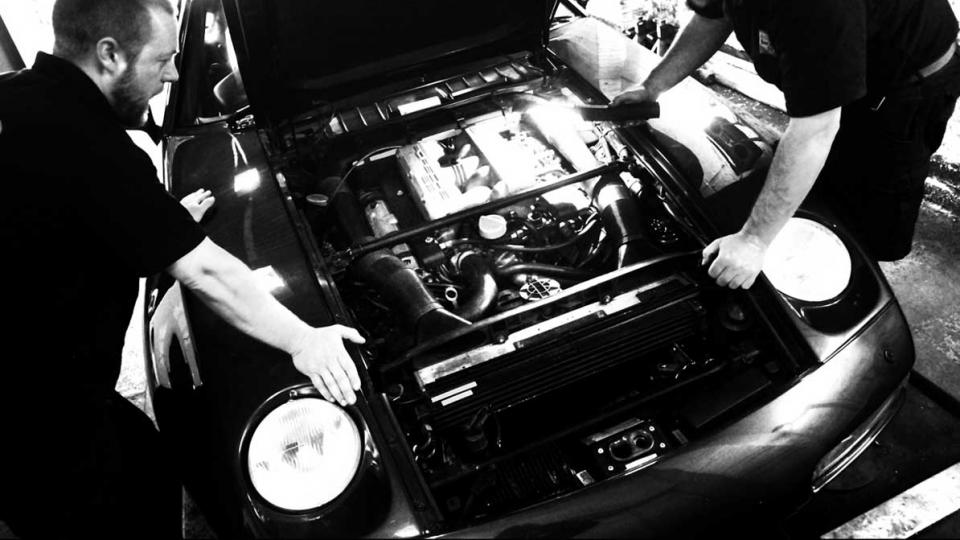 Ashley and Dave listen for an erratic noise from the Porsche 928 V8 engine