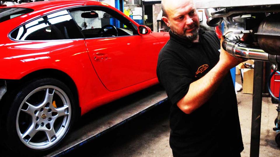 fitting an exhaust silencer to a Porsche 997 model