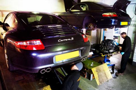 Two Porsche 911's on ramps for repair and inspection