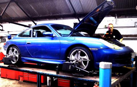 A 996 911 Porsche undergoes wheel alignment