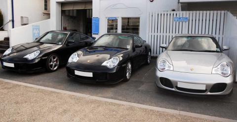 Three Porsche 911 turbos outside the devon garage