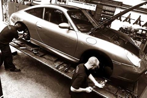 Dave and Matt work to fit new brakes to the Porsche 996 911