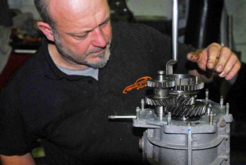 A stripped down Porsche gearbox being inspected